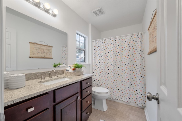 bathroom with hardwood / wood-style floors, vanity, toilet, and a shower with shower curtain