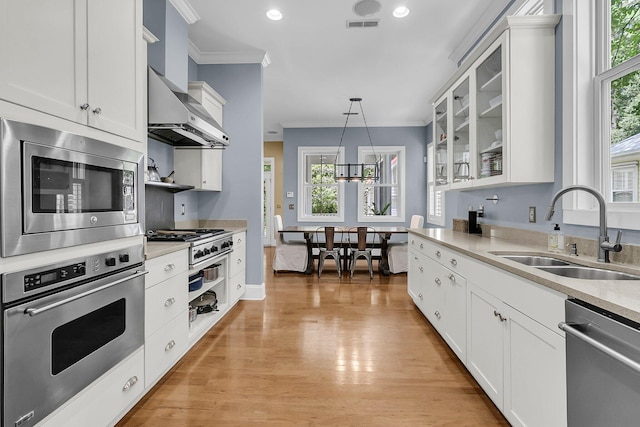 7021 Schooner St, Charleston, SC 29492 - kitchen featuring stainless steel appliances, ornamental molding, healthy amount of natural light, white cabinetry, and recessed lighting