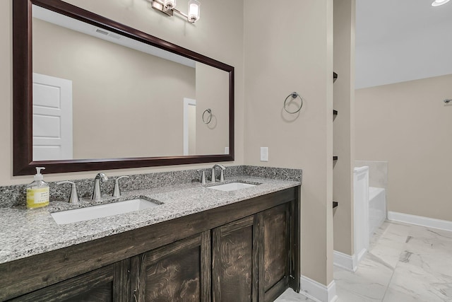 7021 Schooner St, Charleston, SC 29492 - bathroom with marble look tile flooring, double vanity, and a bathtub