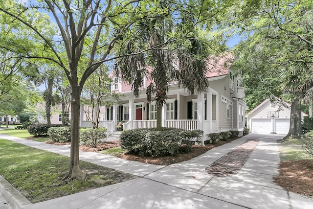 7021 Schooner St, Charleston, SC 29492 - view of front of property with an outdoor structure, a porch, and concrete driveway