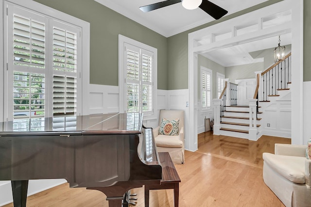 7021 Schooner St, Charleston, SC 29492 - living area with a decorative wall, a wainscoted wall, stairway, ceiling fan, and wood finished floors