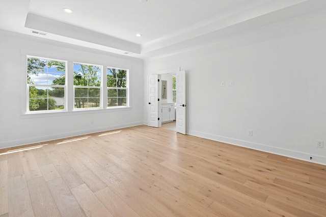 2027 Riverbend Dr, James Island, SC 29412 - spare room featuring a tray ceiling, light wood-type flooring, and recessed lighting