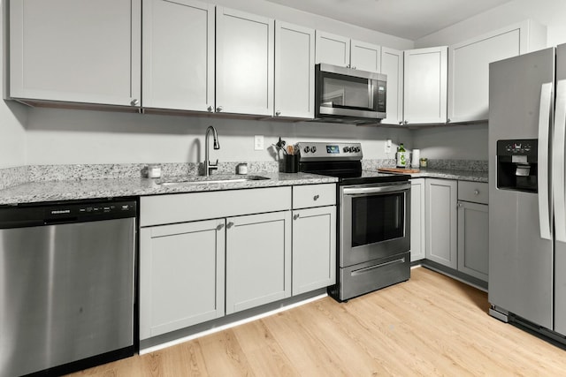 120 Lisa Dr, Summerville, SC 29485 - kitchen with light wood-type flooring, light stone counters, a sink, and appliances with stainless steel finishes