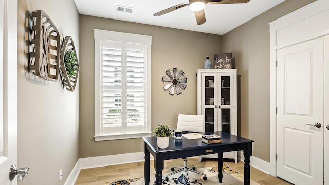 home office with ceiling fan and a healthy amount of sunlight