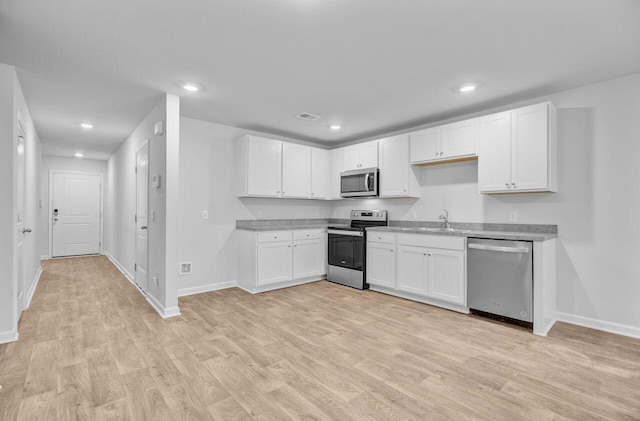407 Spruce Ivy St, Moncks Corner, SC 29461 - kitchen with stainless steel appliances, baseboards, light wood-style flooring, and recessed lighting