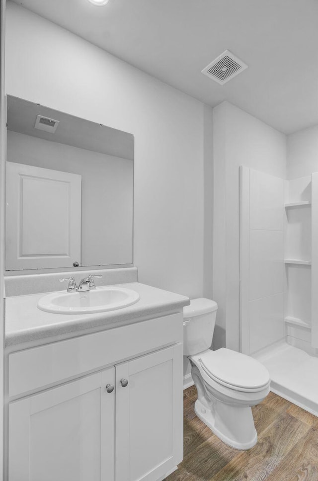407 Spruce Ivy St, Moncks Corner, SC 29461 - full bath featuring wood finished floors, vanity, a shower stall, and toilet