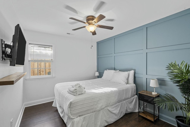 bedroom with ceiling fan and dark hardwood / wood-style flooring