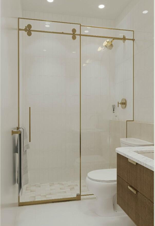 bathroom featuring vanity, an enclosed shower, tile patterned flooring, and toilet