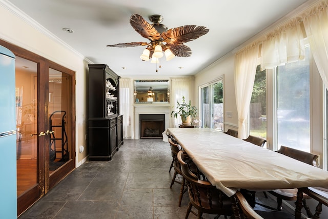 3347 Walter Dr, Johns Island, SC 29455 - dining space featuring a fireplace, crown molding, a ceiling fan, and dark stone finish flooring