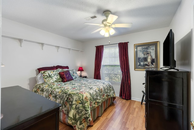 3347 Walter Dr, Johns Island, SC 29455 - bedroom with light wood finished floors, ceiling fan, and a textured ceiling