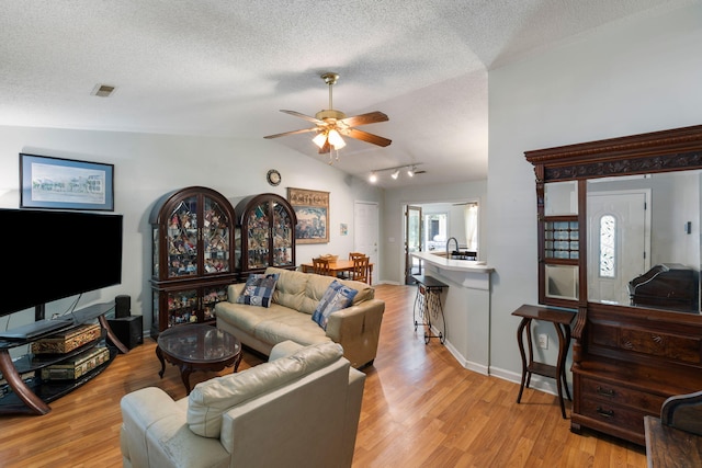 3347 Walter Dr, Johns Island, SC 29455 - living area featuring lofted ceiling, light wood finished floors, a textured ceiling, and ceiling fan