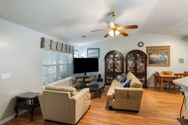 3347 Walter Dr, Johns Island, SC 29455 - living room with lofted ceiling, ceiling fan, light wood-type flooring, and a textured ceiling