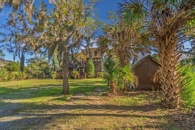 7897 Russell Creek Dr, Edisto Island, SC 29438 - view of green lawn featuring a storage shed and a wooden deck