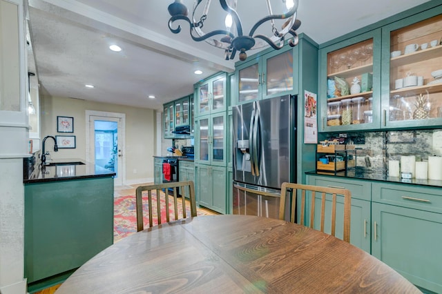 dining space with a chandelier, baseboards, and recessed lighting