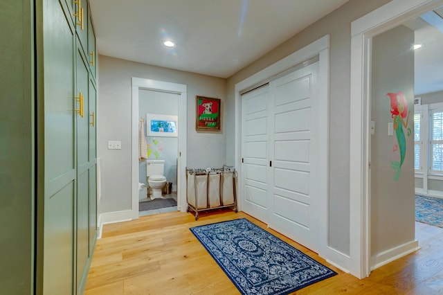 entryway with recessed lighting, light wood-style flooring, and baseboards