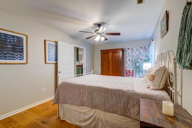 bedroom featuring light wood-type flooring, ceiling fan, and baseboards