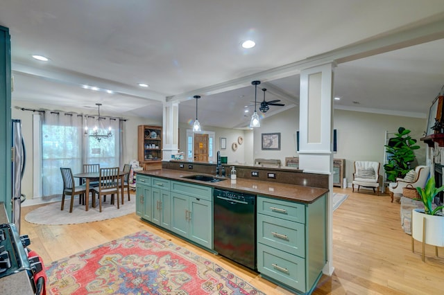 kitchen with dark countertops, appliances with stainless steel finishes, green cabinets, and a sink