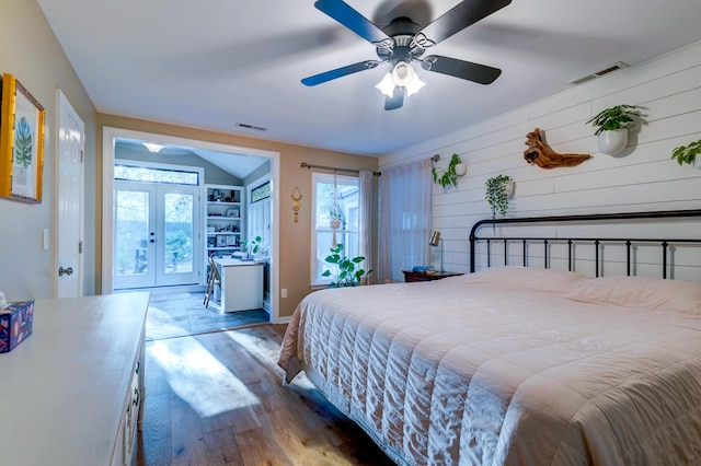 bedroom featuring access to outside, french doors, visible vents, and wood finished floors