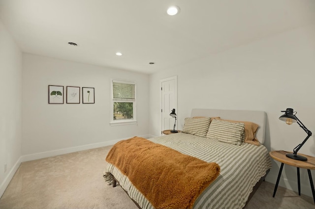 bedroom featuring light carpet