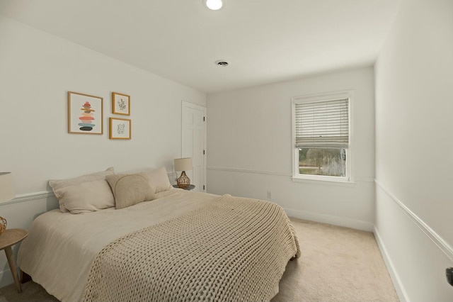 bedroom featuring light carpet