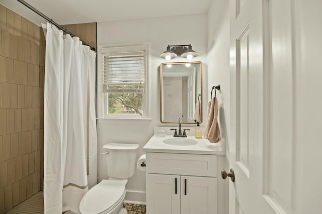 bathroom with vanity, curtained shower, and toilet