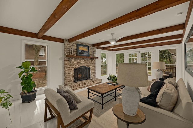 tiled living room with beamed ceiling, ceiling fan, and a fireplace