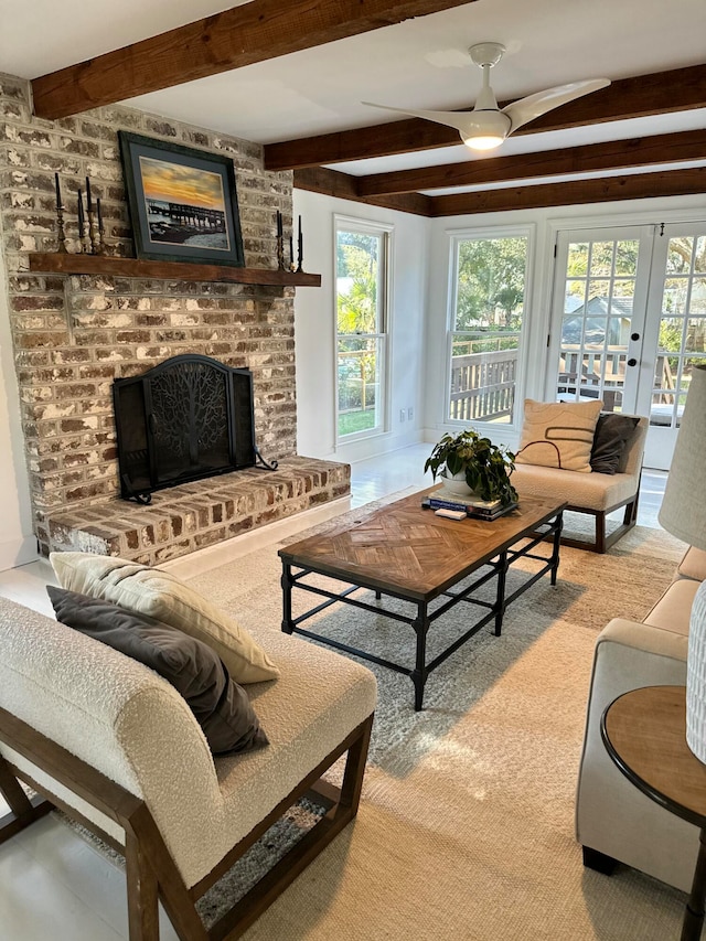 carpeted living room featuring a wealth of natural light, a fireplace, beamed ceiling, and ceiling fan