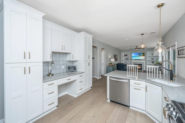 468 Maple Oak Ln, Charleston, SC 29414 - kitchen featuring stainless steel appliances, arched walkways, open floor plan, decorative backsplash, and light wood finished floors