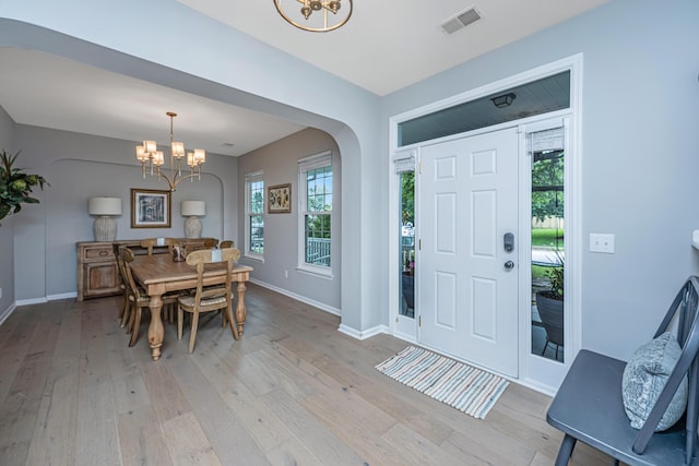 468 Maple Oak Ln, Charleston, SC 29414 - foyer with a chandelier, light wood-style flooring, and arched walkways