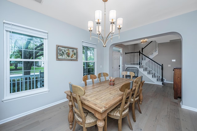 468 Maple Oak Ln, Charleston, SC 29414 - dining area featuring arched walkways, stairway, light wood-type flooring, and healthy amount of natural light