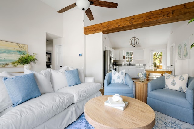 living area with ceiling fan and lofted ceiling with beams