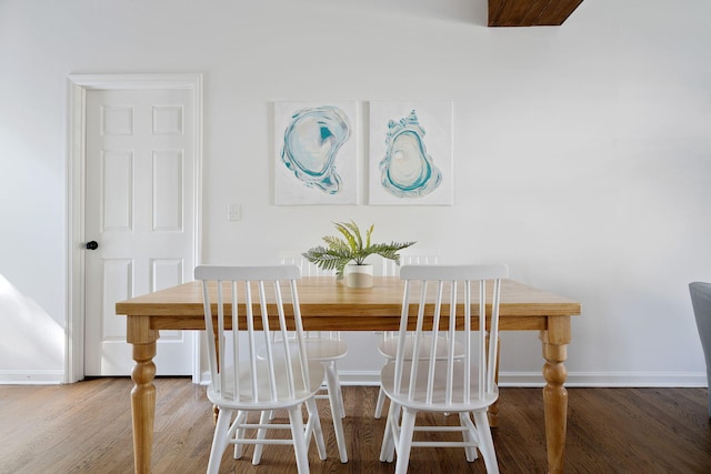 dining area with wood finished floors and baseboards