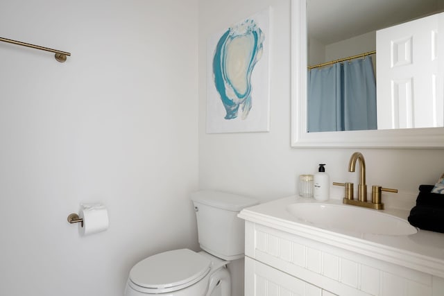 full bath featuring toilet and vanity