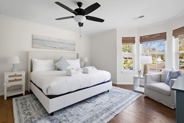 bedroom featuring ornamental molding, multiple windows, and visible vents