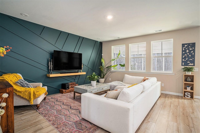 living room featuring light wood-style flooring, recessed lighting, baseboards, and visible vents