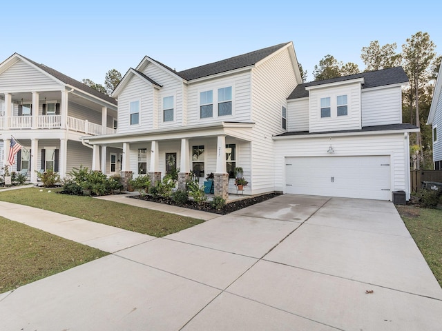 view of front of property with a shingled roof, a front lawn, a porch, concrete driveway, and an attached garage