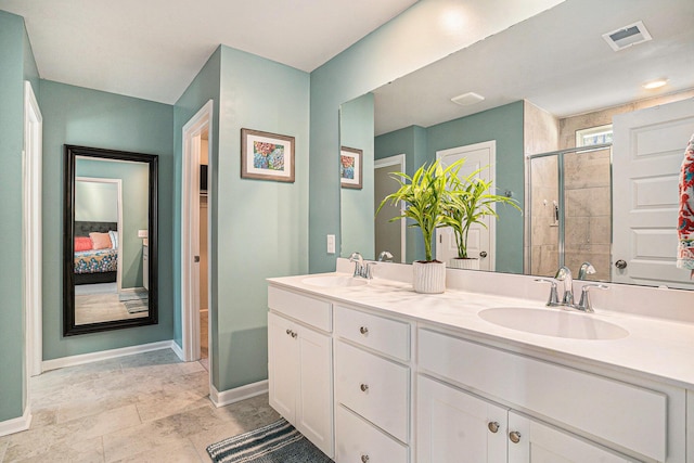 ensuite bathroom with a tile shower, visible vents, ensuite bathroom, and a sink