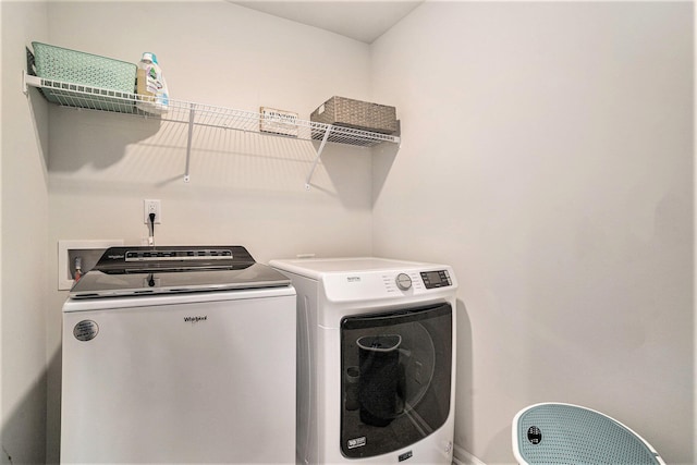 laundry room with washer and dryer and laundry area