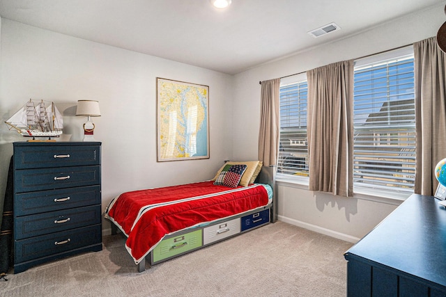 carpeted bedroom with visible vents and baseboards