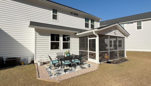 rear view of house with a patio and a sunroom