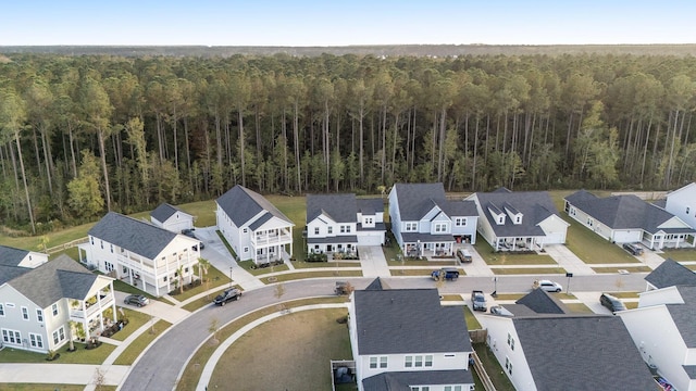 drone / aerial view with a forest view and a residential view