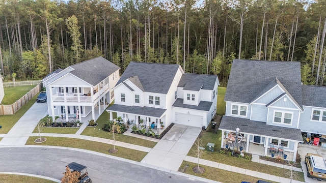 birds eye view of property featuring a view of trees