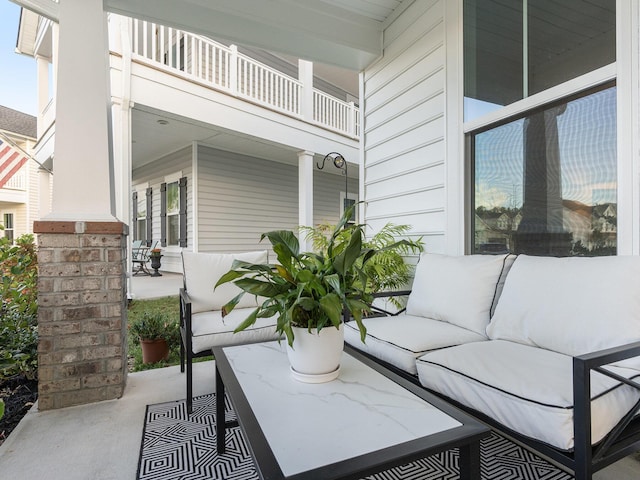 view of patio / terrace featuring covered porch, an outdoor hangout area, and a balcony