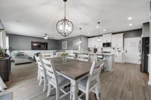 dining room featuring recessed lighting, wood finished floors, and a chandelier