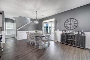 dining room featuring wood finished floors and a chandelier