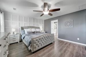 bedroom featuring dark wood finished floors, baseboards, and ceiling fan