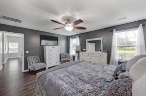 bedroom with dark wood-type flooring and visible vents