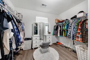 walk in closet with visible vents and wood finished floors