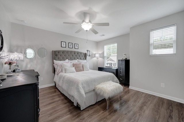 bedroom featuring ceiling fan, baseboards, and wood finished floors