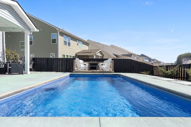 view of swimming pool featuring a fenced in pool, a fenced backyard, and a patio area